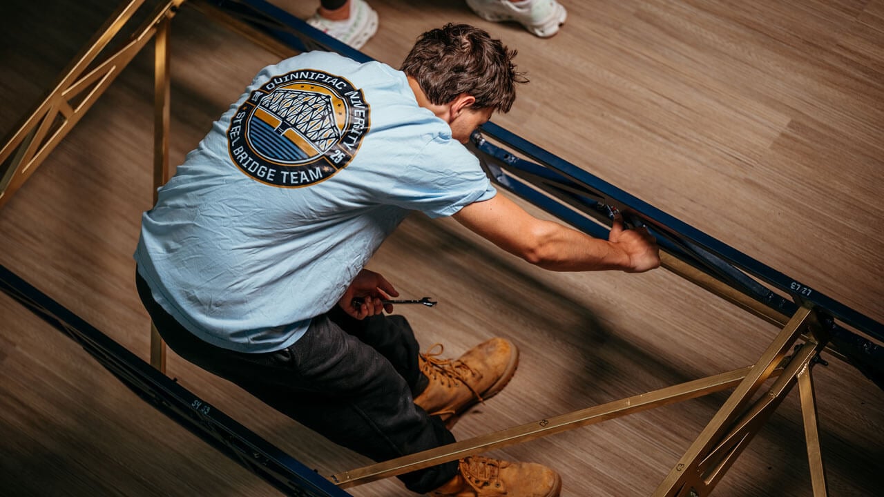 Student works on building a bridge