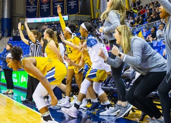 Women's basketball players cheer