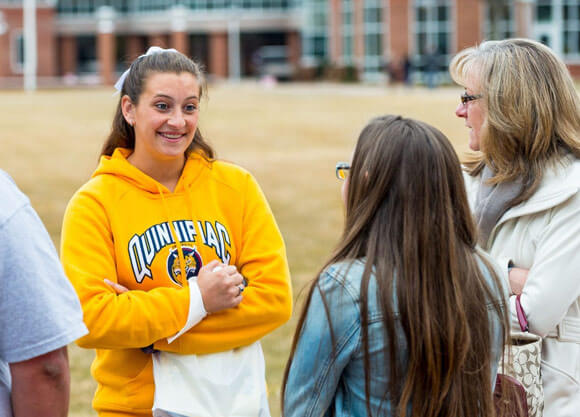 Talking to a prospective student and parents on Admitted Students Day