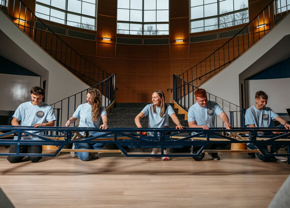 Students work together to build a steel bridge