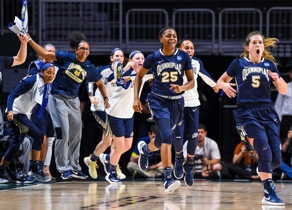 Woman's basketball team members cheering