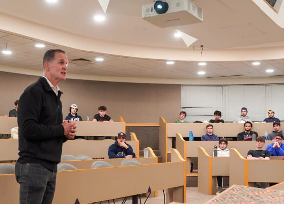 Tom Ellett speaks to a room of students
