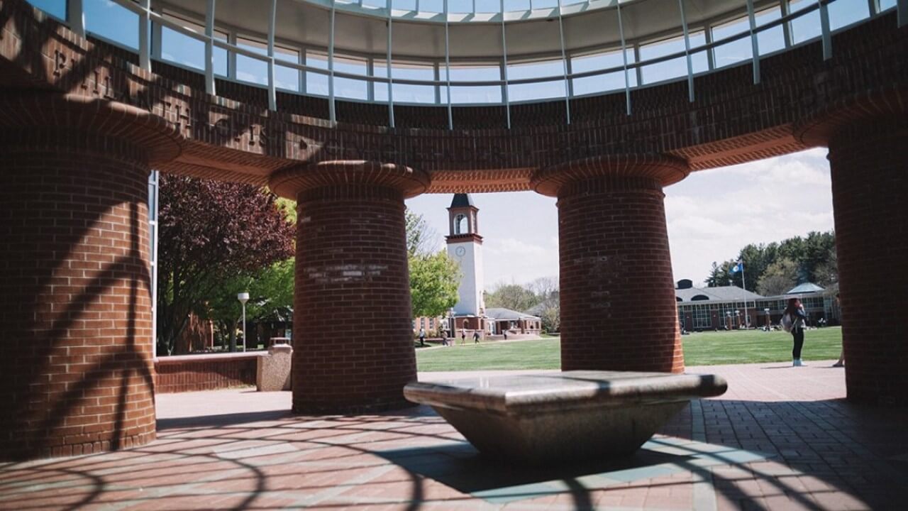 The Arnold Bernhard Library is seen through the Lender School of Business Center dome