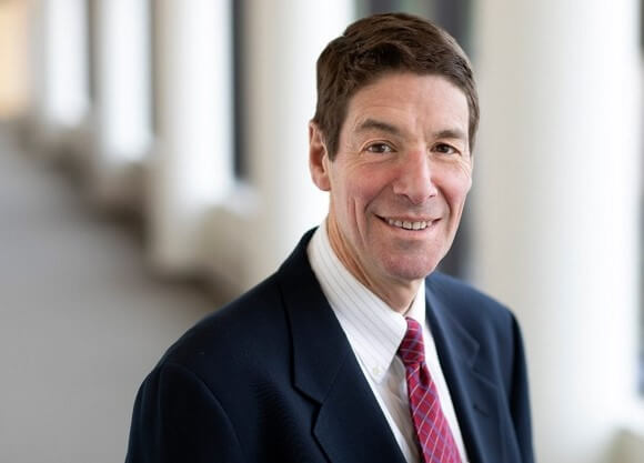 Dr. Howard Selinger poses for a photograph in a suit and tie