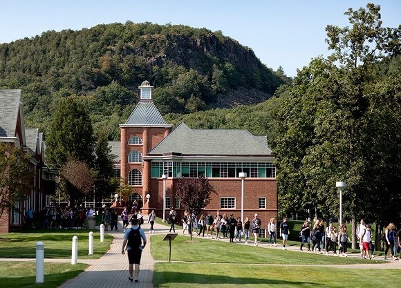 Students walk outside in front of the Center for Communications and Engineering
