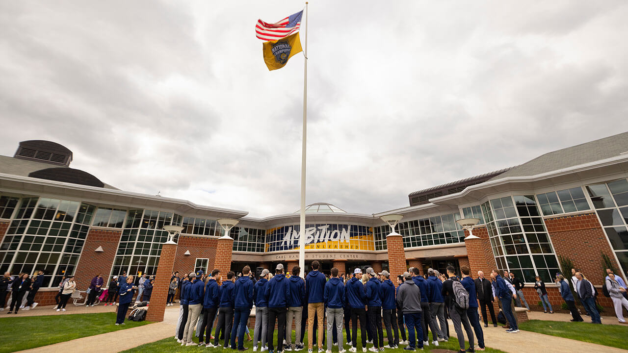 Wide view of spectators watching the flag raising