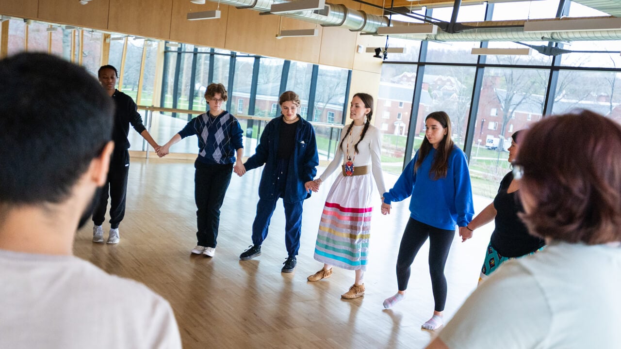A group of people holding hands in a circle