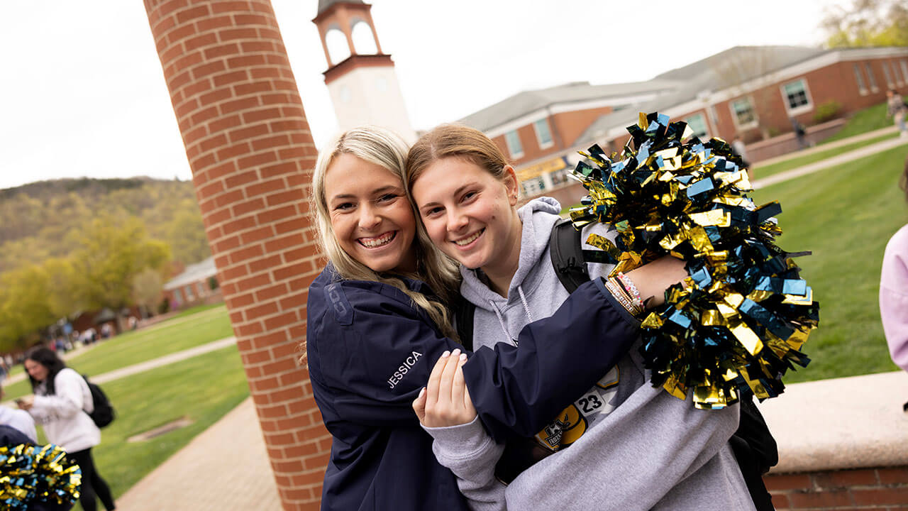 Girls smile as they attend the national championship flag raising