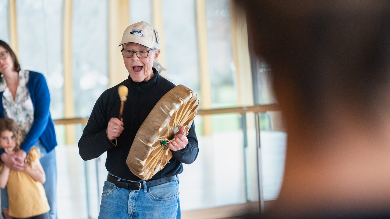 A woman hitting a tribal drum