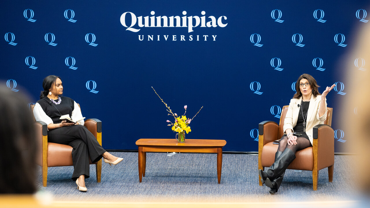 Sarah Harris and Jennifer Rawlings having a conversation while seated in comfy chairs