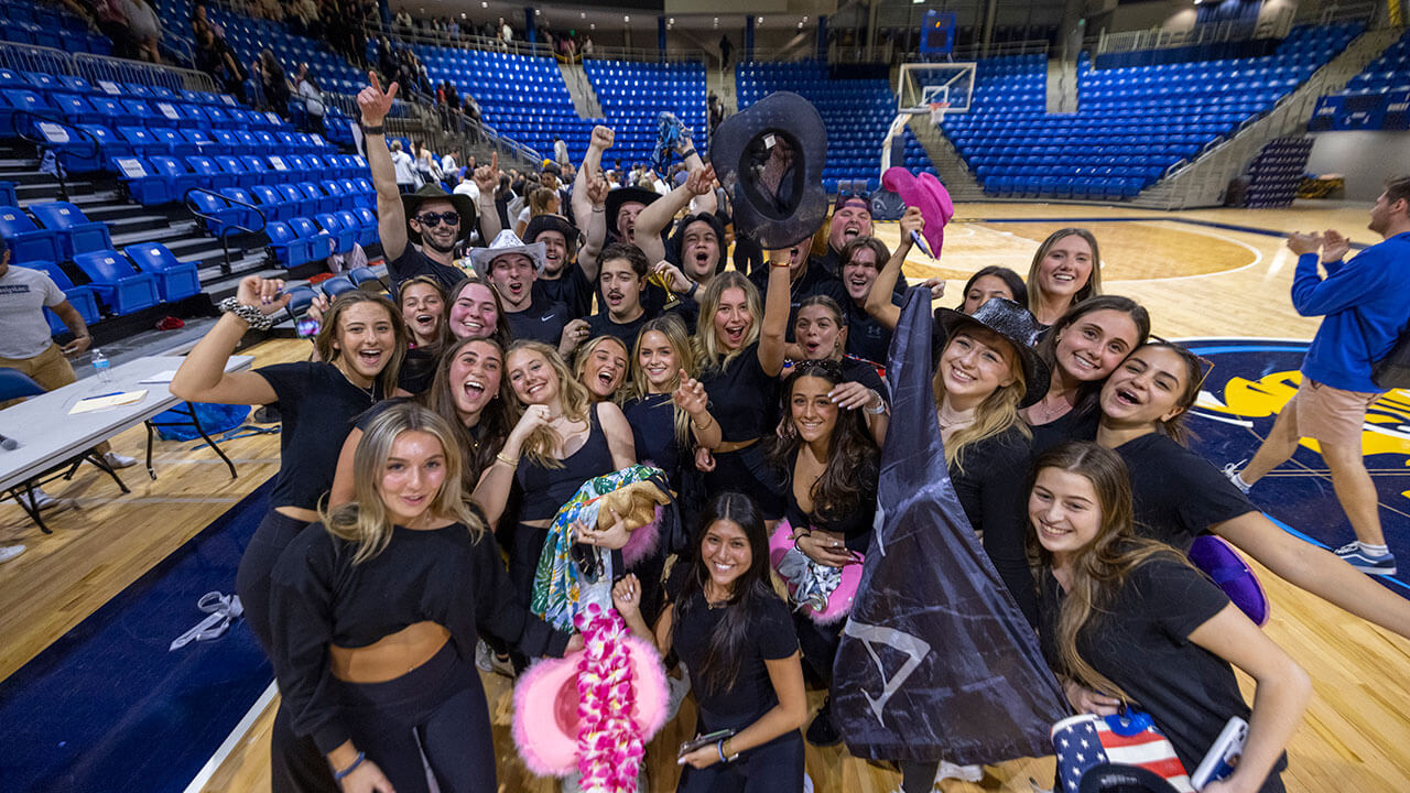 The winning team smiles and takes a photo with the Lip Sync trophy