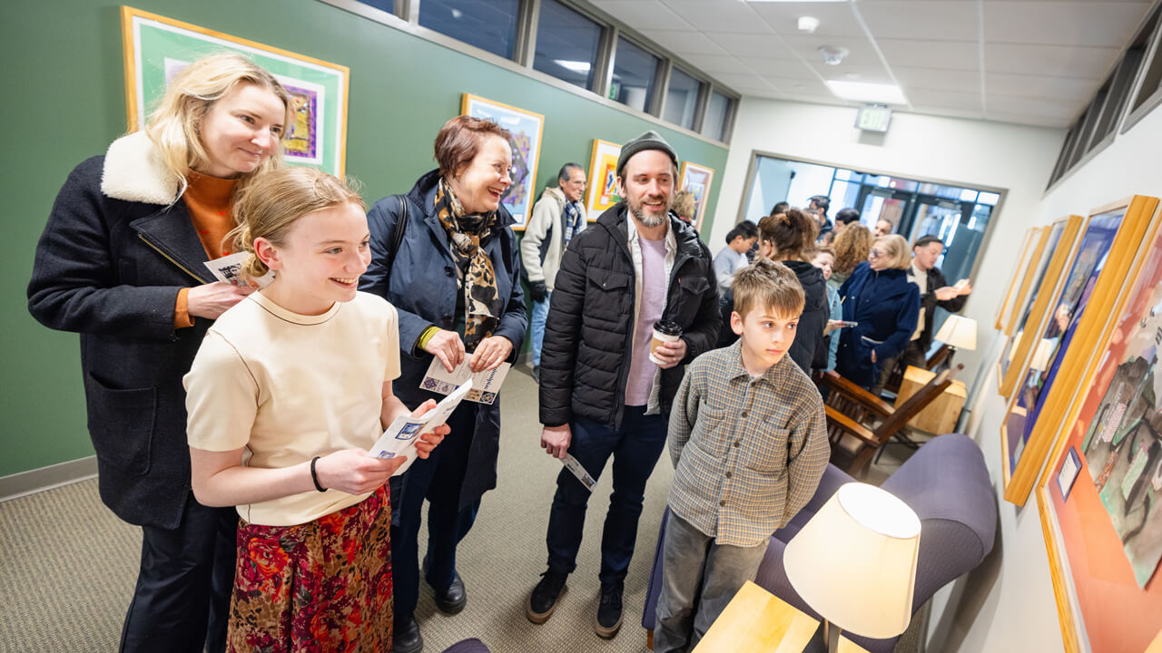 Twelve-year-old Adiah Powell, a seventh-grade student at Hamden Middle School, shows her artwork to — from left — her mother, Kristy Heart of Hamden; family friend Leslie Dick; father Russ Powell; and 9-year-old brother Walden Powell during the Kaleidoscope of Creativity event.