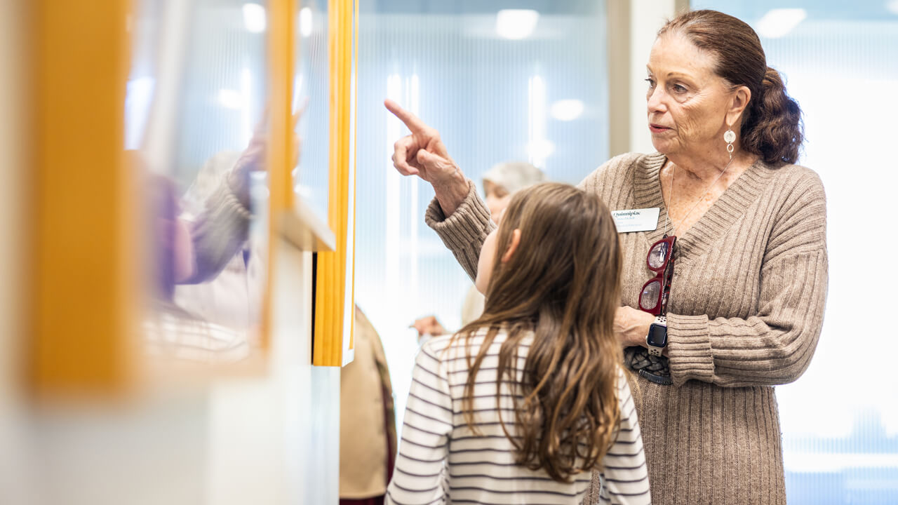 Dean of the Quinnipiac University School of Education Anne M. Dichele views local students’ artwork during the Kaleidoscope of Creativity event.