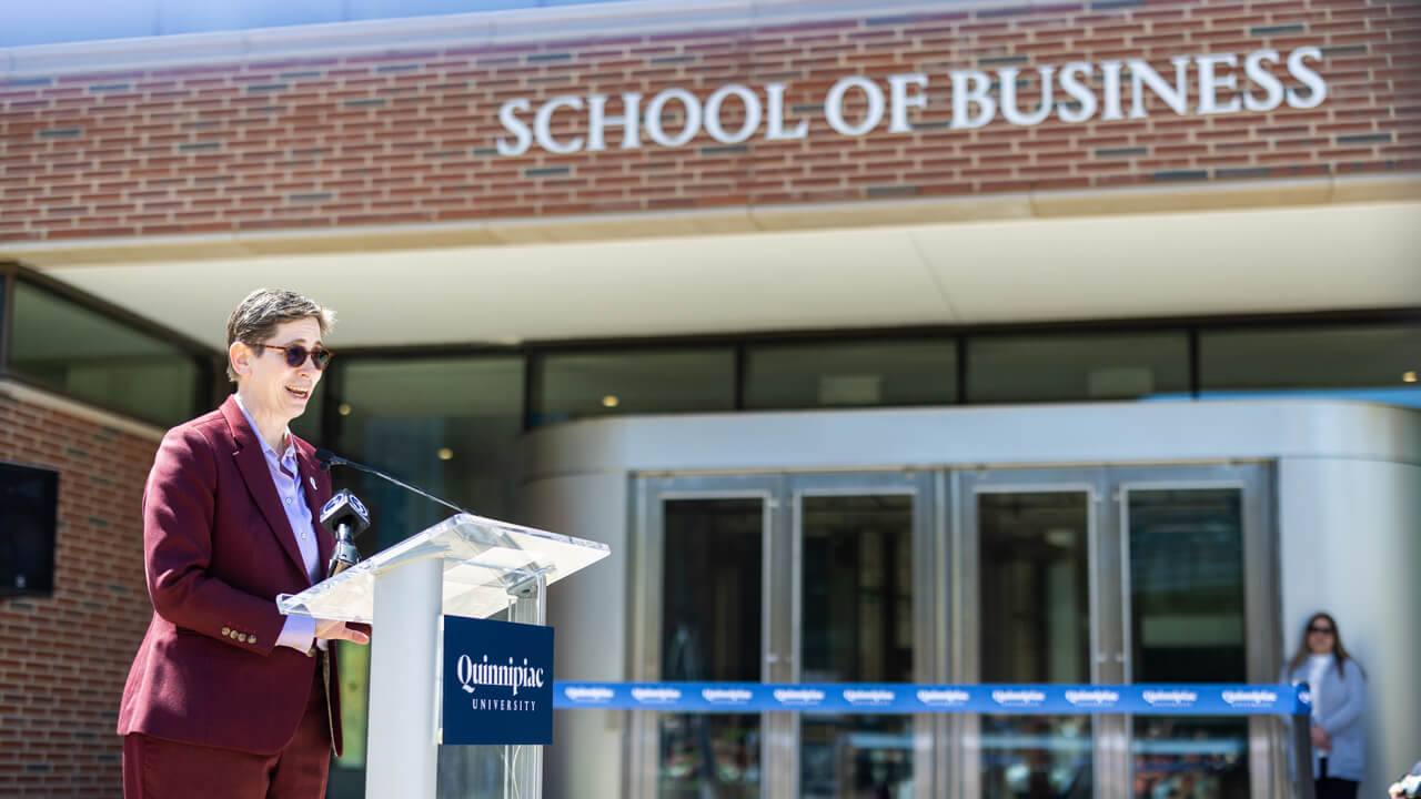 Debra Liebowitz stands at a podium speaking
