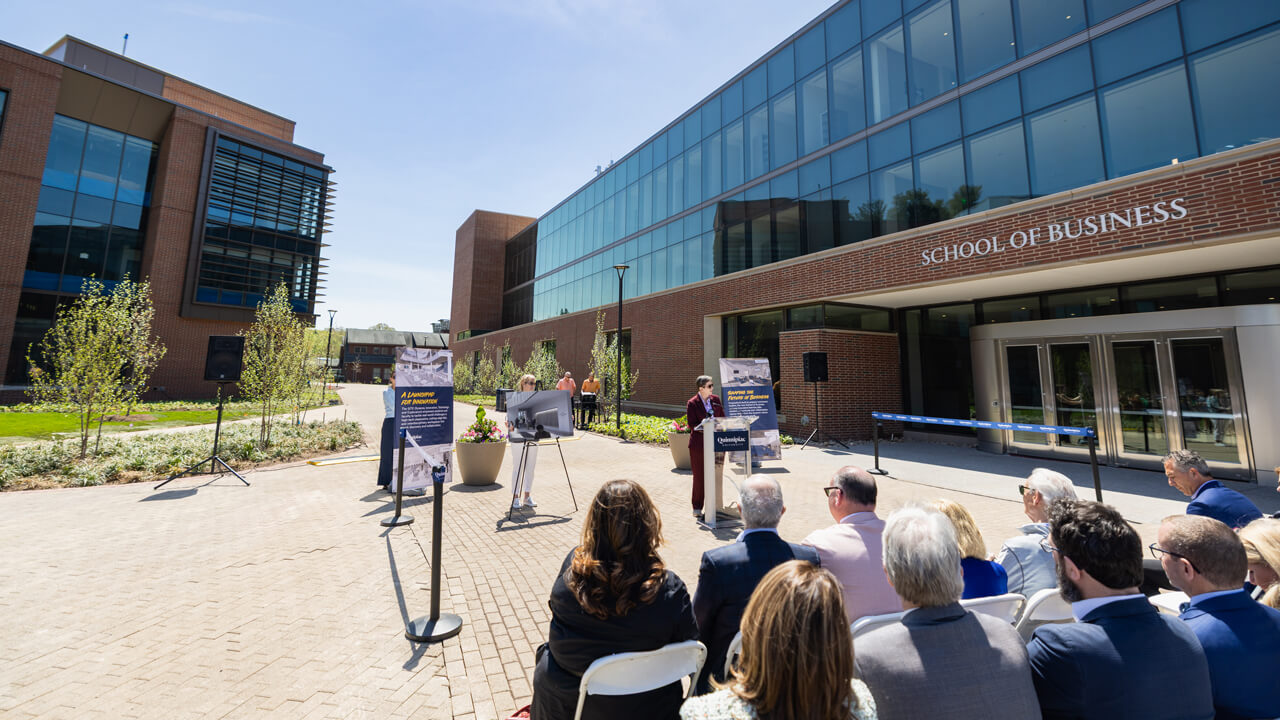 Debra Liebowitz stands a podium