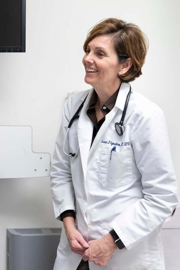 Clinical Assistant Professor of Nursing and Nurse Practitioner Program Director Susan D’Agostino, DNP, performs a routine check-up on a patient.