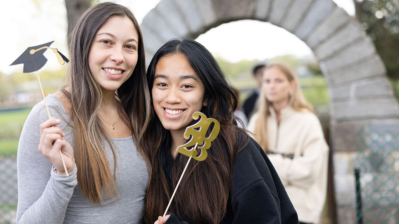 Student pose for a picture at the alumni gardens