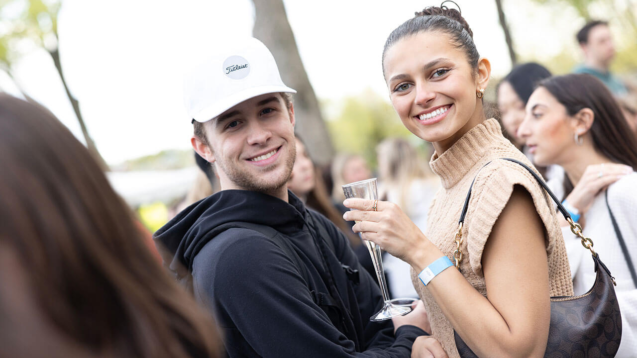Students smile and laugh as they talk with their friends