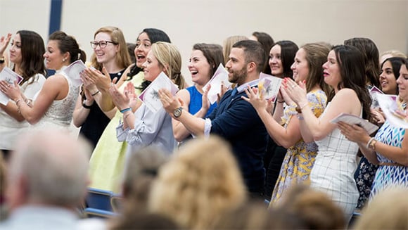 Students taking part in a pinning ceremony.