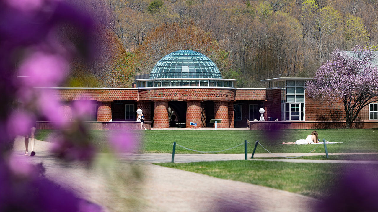 Exterior shot of the School of Business with Spring flowers around the frame