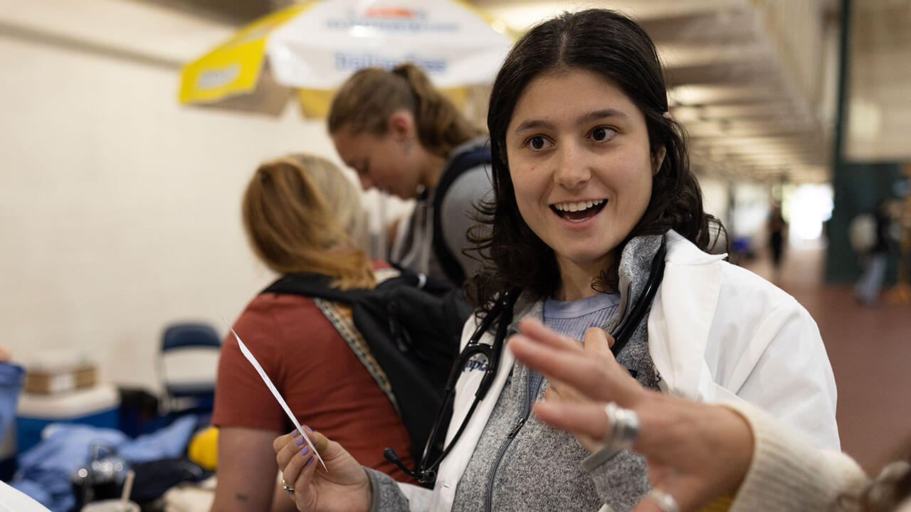 Woman in lab coat smiling