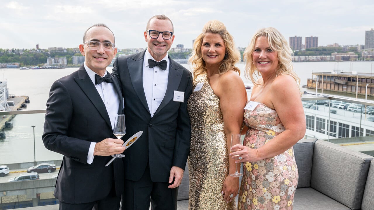 Four people pose for a photo