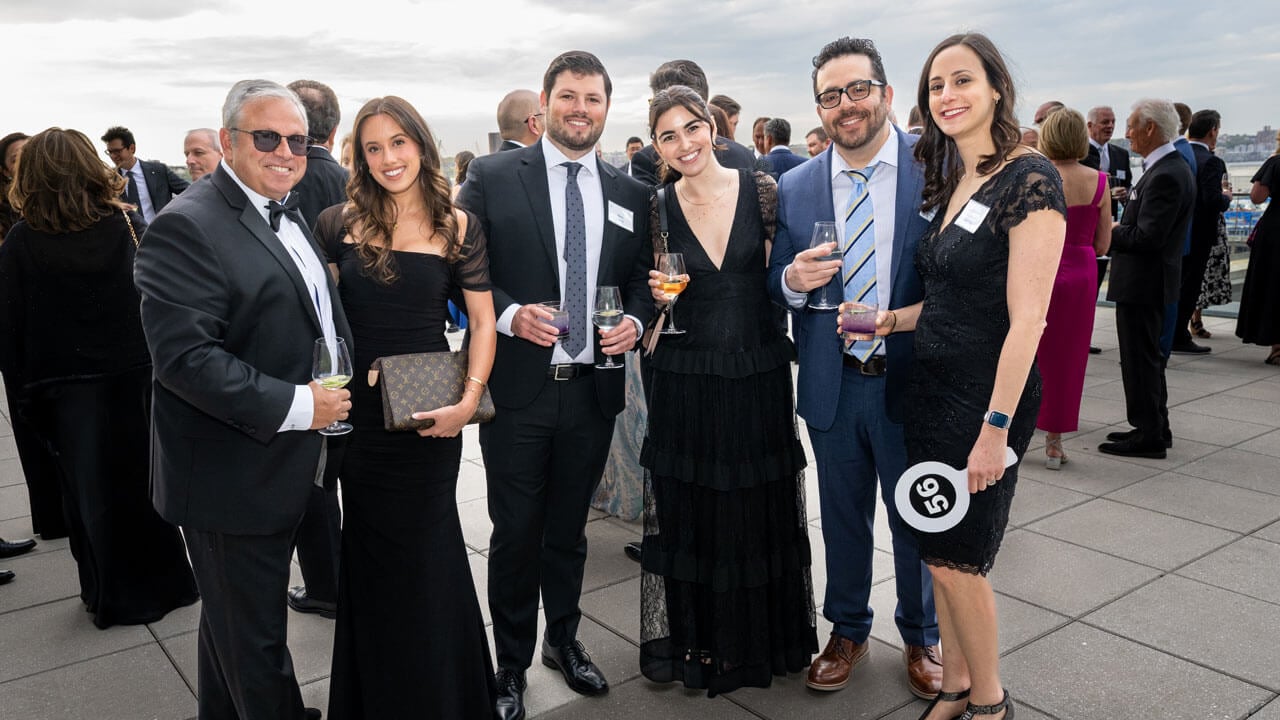 Six people pose for a photo