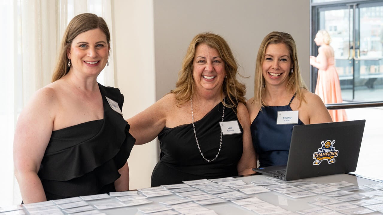 Three people pose for a photo