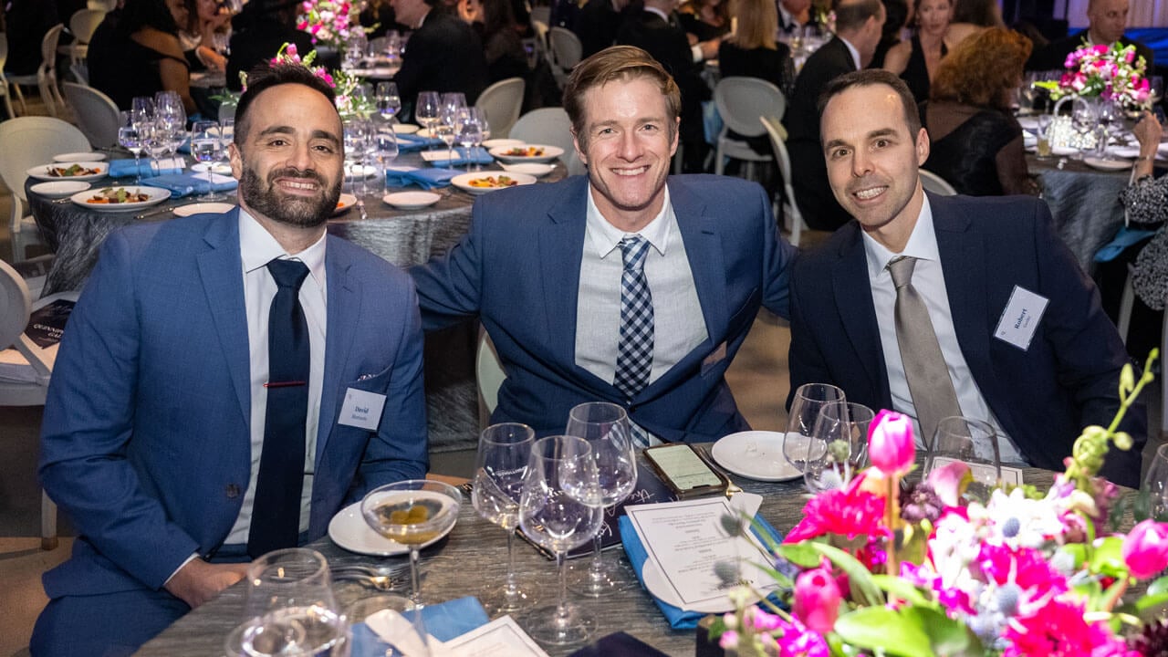 Three people pose for a photo