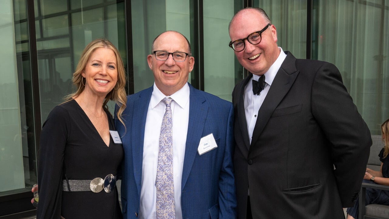 Three people pose for a photo