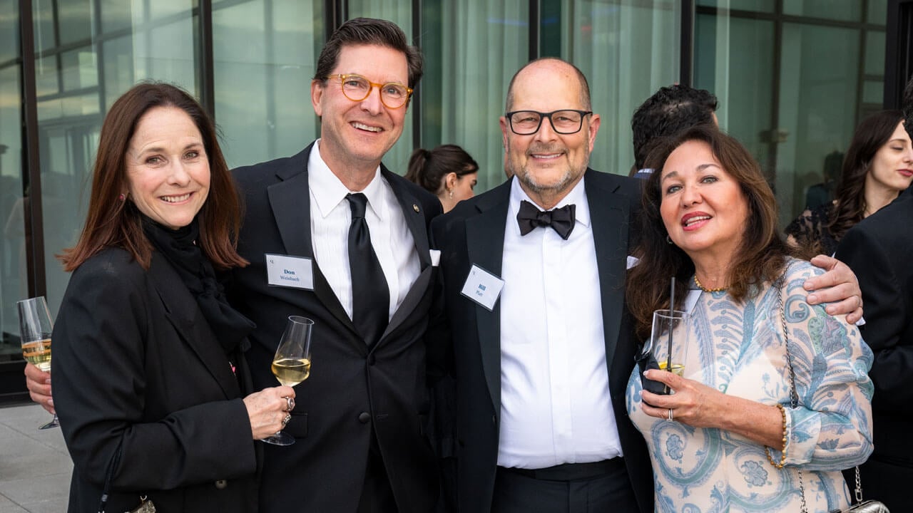 Four people pose for a photo