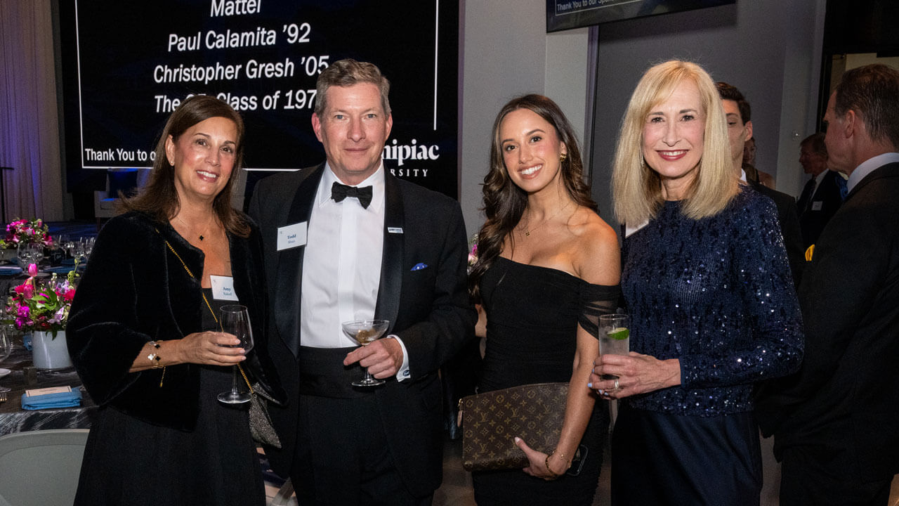 Four people pose for a photo