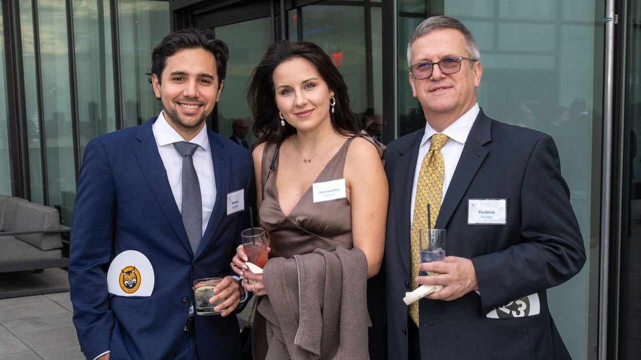 Three people pose for a photo
