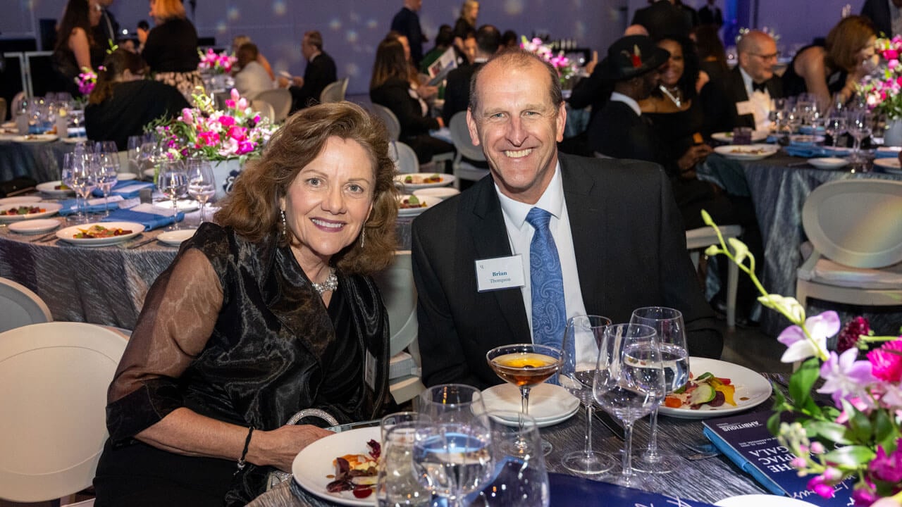 Two people pose for a photo