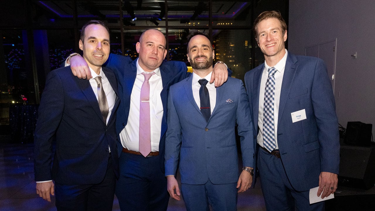 Group of people smile for a photo.