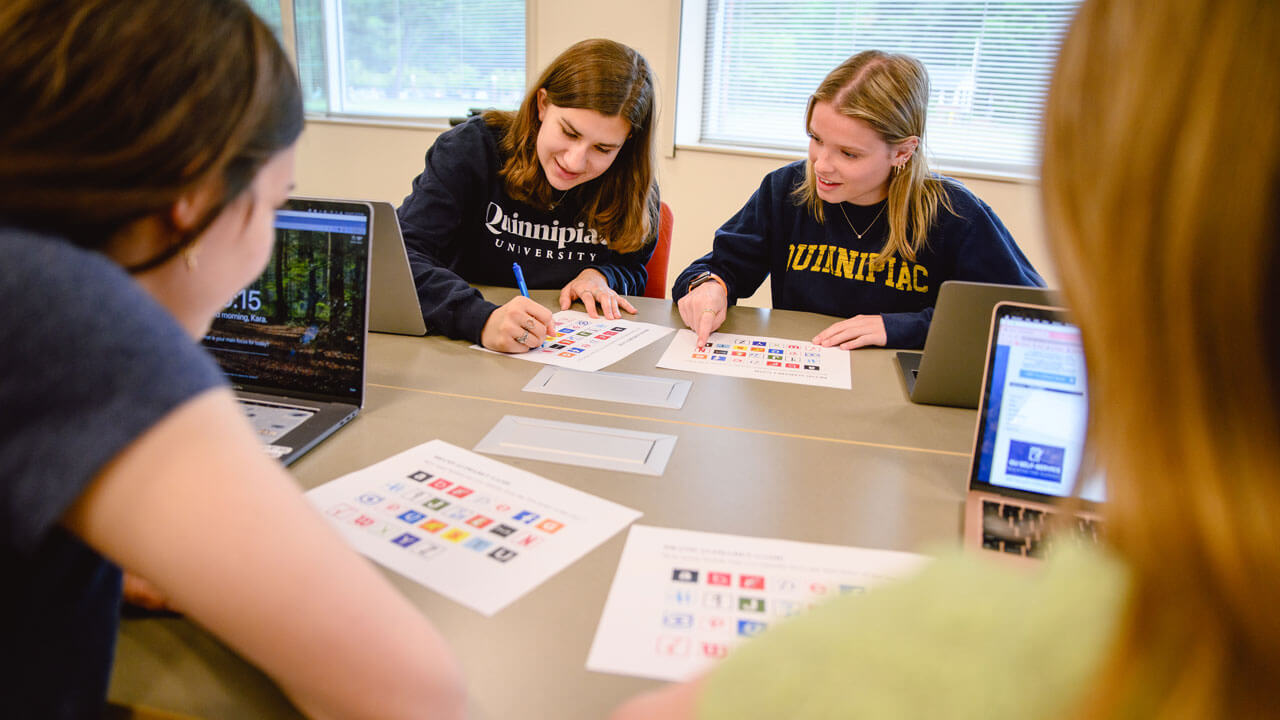 4 students work on a graphic design project