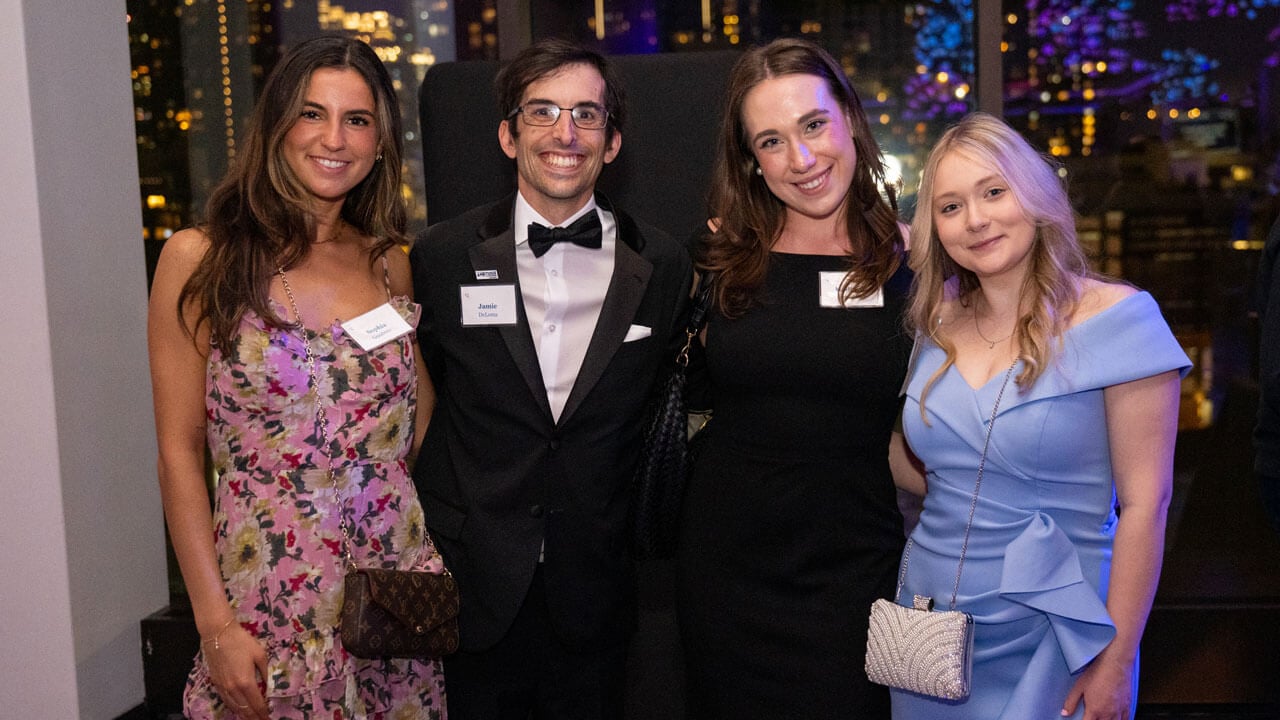 Four people pose for a photo