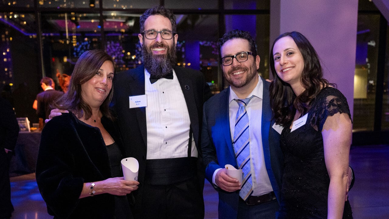 Four people pose for a photo