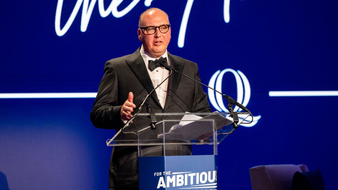 Brett Amendola speaks at a podium