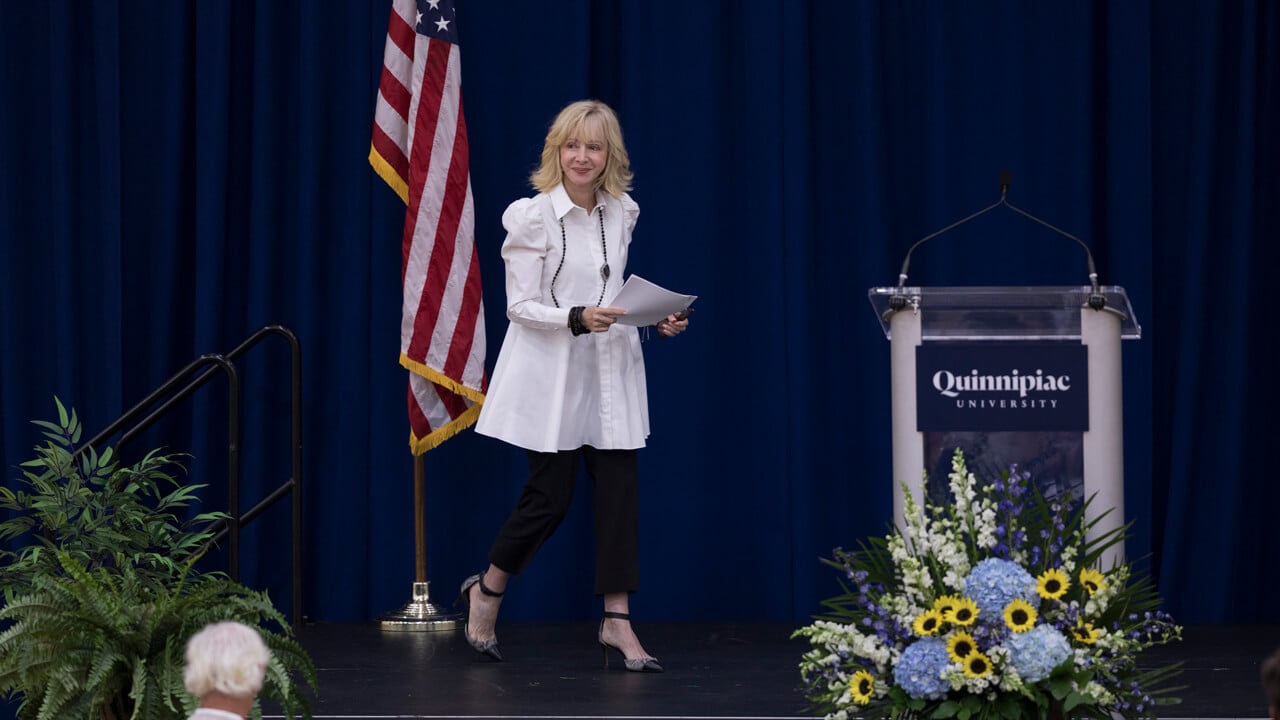 Judy Olian walks on stage