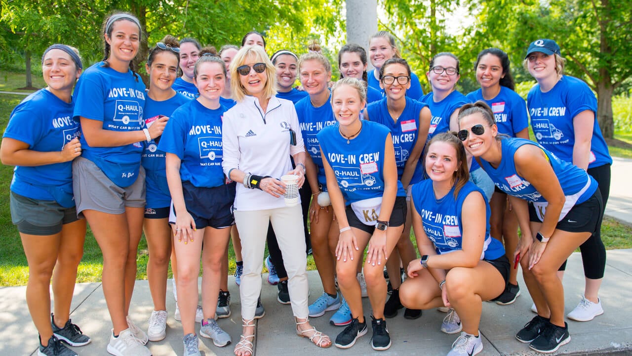 Judy Olian poses with students