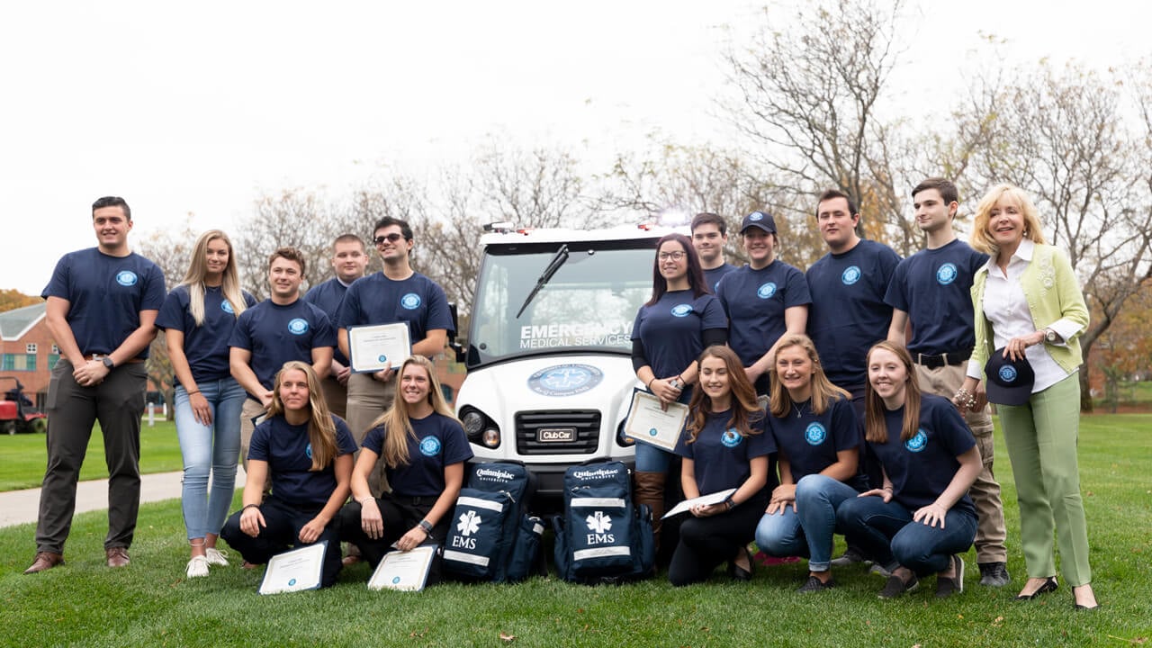 Judy Olian poses with Quinnipiac EMS
