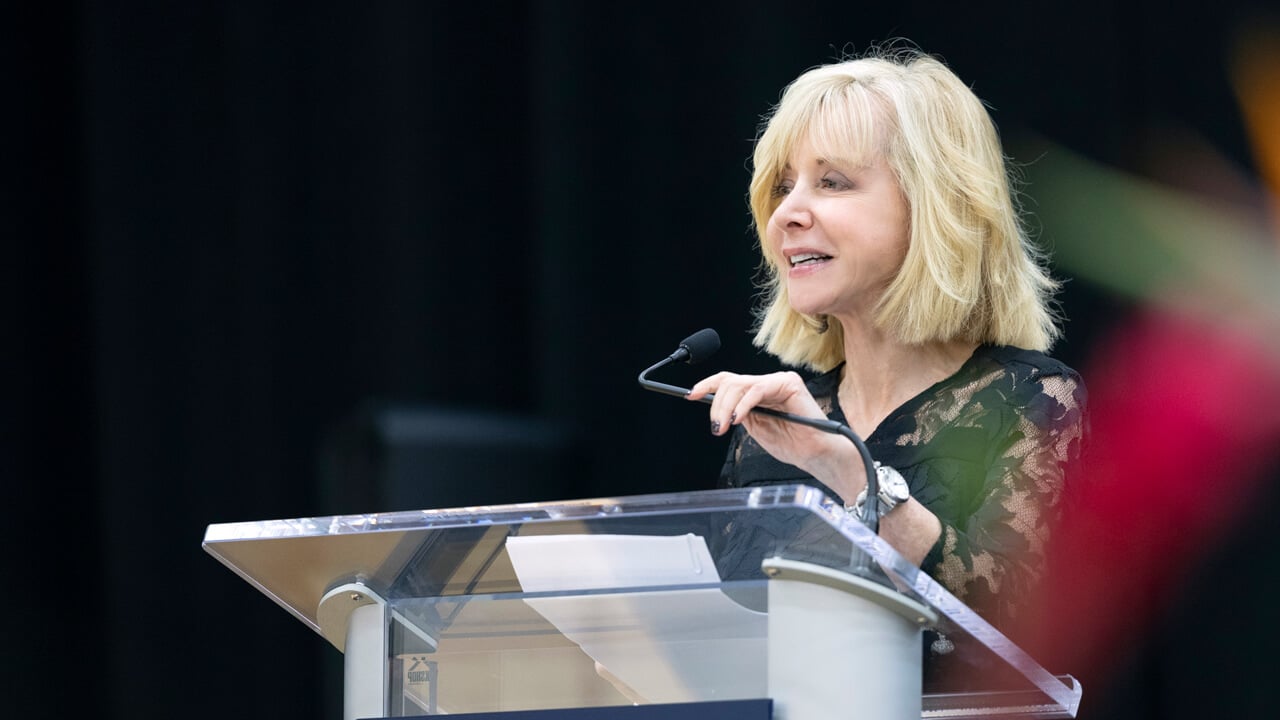 Judy Olian speaks at a podium