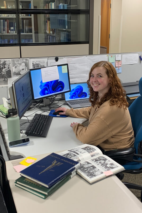 Student sitting and working on a computer in the Arnold Bernhard Library