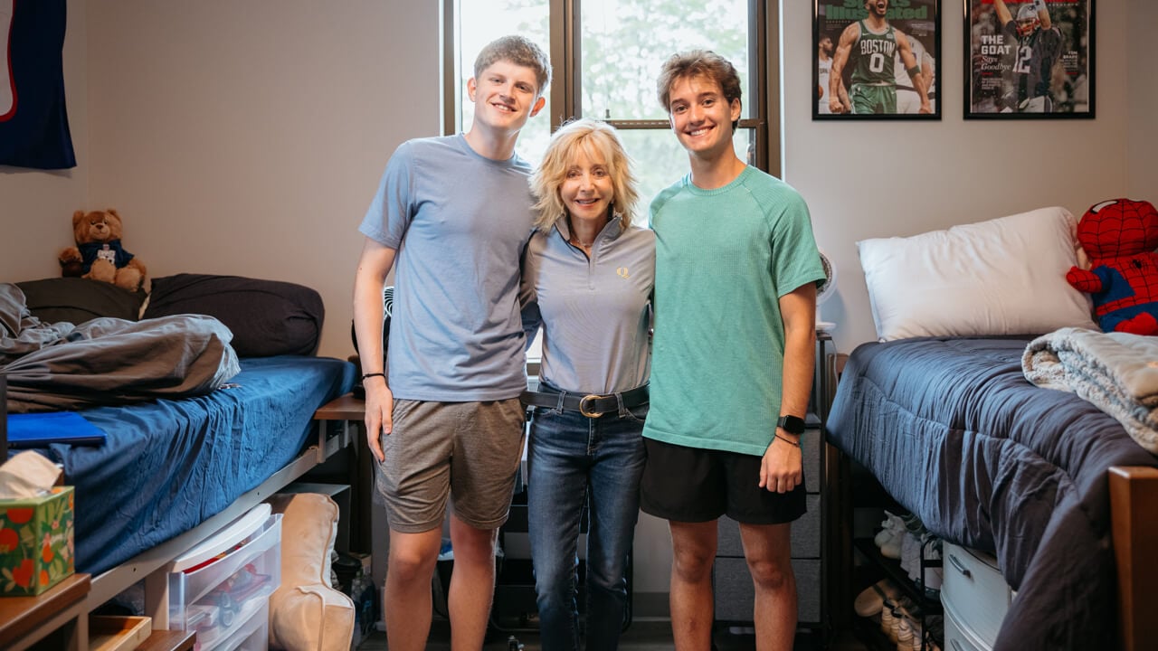 Judy Olian poses for a photo with students