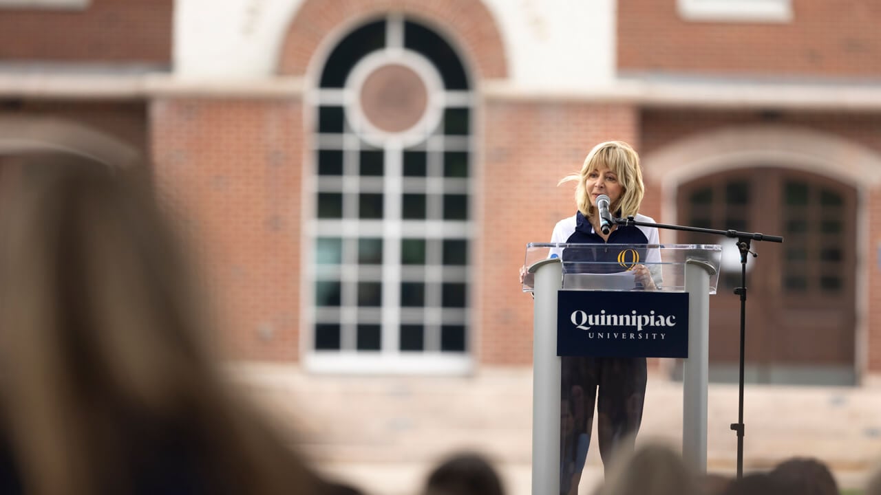 Judy Olian speaks at a podium