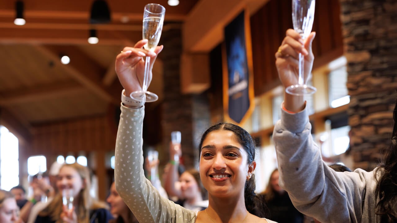 Student holds a champagne class