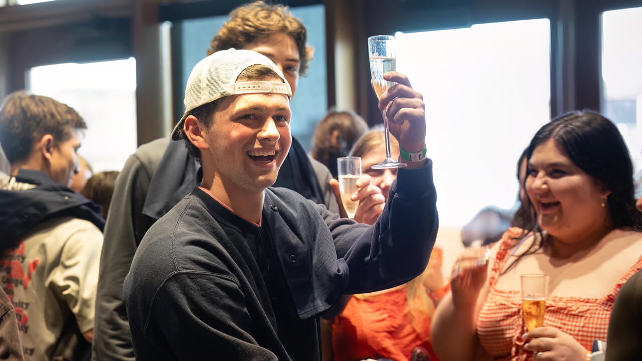 Student holds a champagne class
