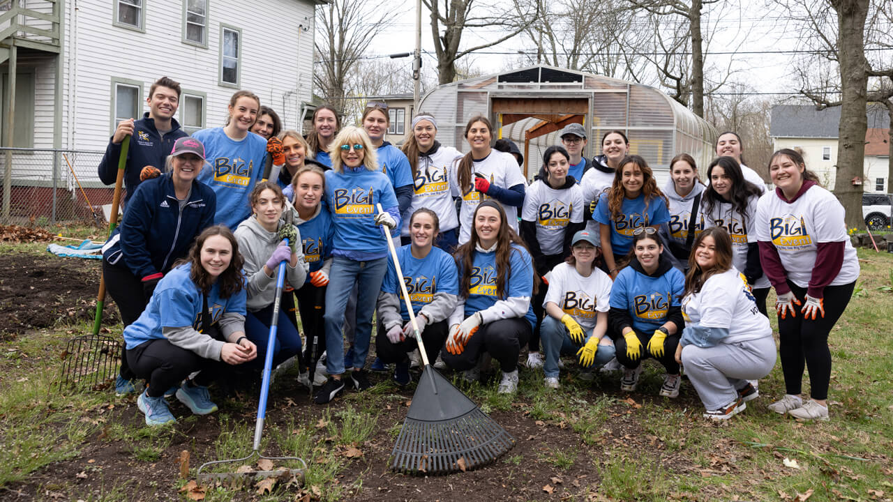 Judy Olian poses for a photo with students
