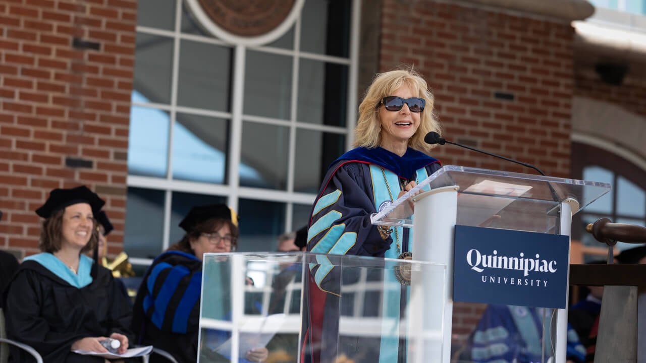 Judy Olian speaks at a podium